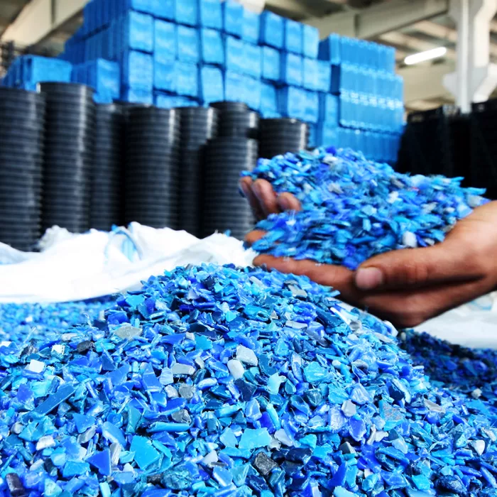 A worker sorts polymers in manufacturing assembly. Exponent polymer science and materials chemistry consulting. 