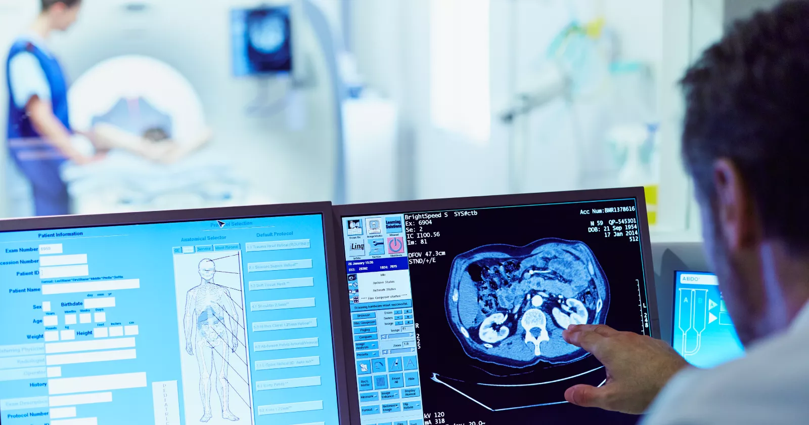 Experts examine internal organ scan on computer screen. Exponent examines medical devices for safety, compliance and resiliency.