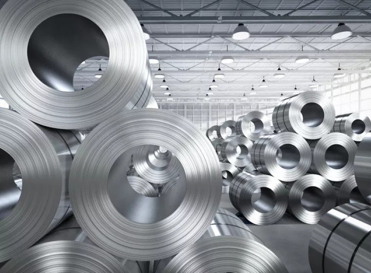 Large rolls of industrial steel in a factory setting. Exponent engineers help with all types of industrial & manufacturing challenges.